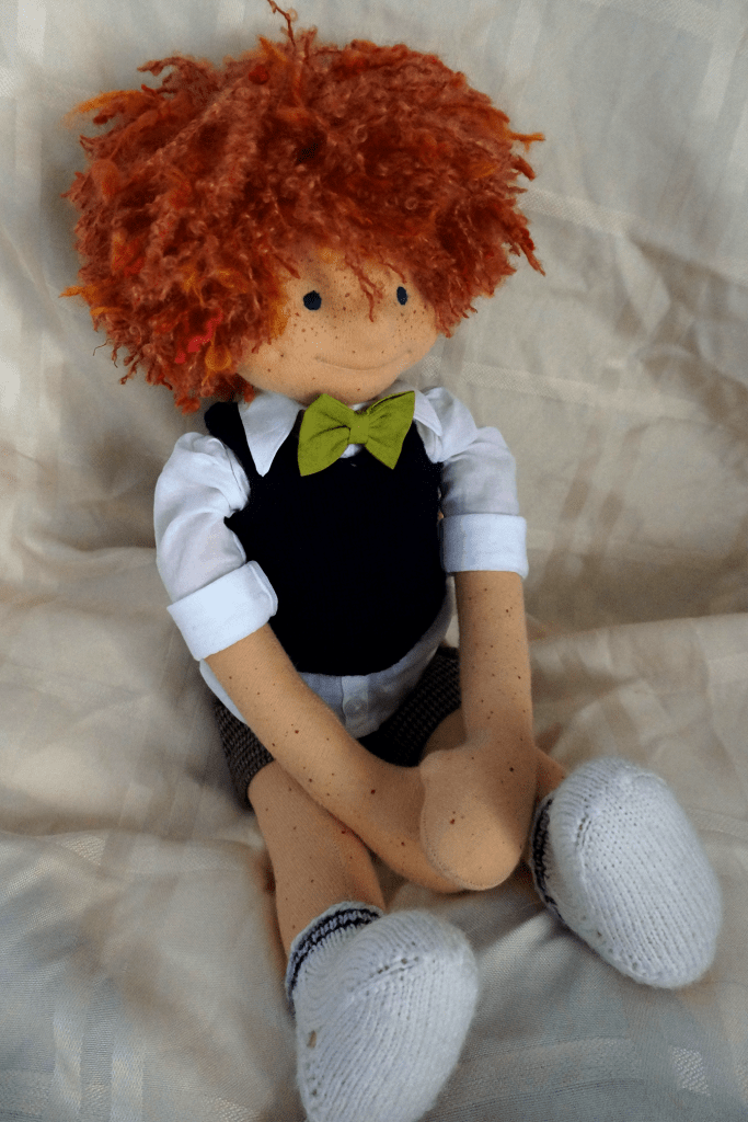 Angus McDonald, wearing his schoolboy outfit and socks but no shoes