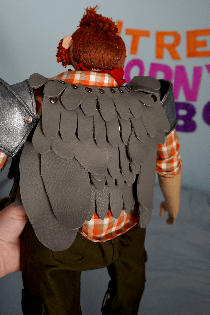 The back of Magnus' grey leather feather chestpiece